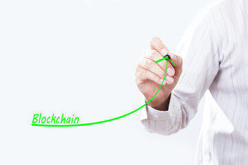 Businessman hand writing growth graph for blockchain.
