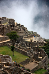 UNESCO World Heritage Site Machu Picchu on top of a Mountain Ridge above the Sacred Valley within the Rainforest in the Andes Mountain Range in Peru