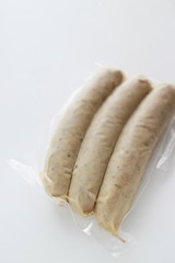 Packed food, pork and spice sausage on white background with copy space