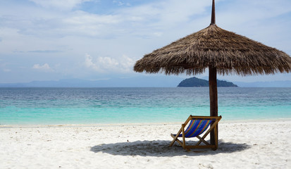 Natural leaves tropical parasol on the beach  with blue sea background outdoor