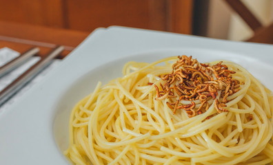 Spaghetti with worms dish placed on the table ready to eat