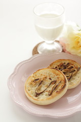 Peanut butter and chocolate on toasted English muffin on pink dish