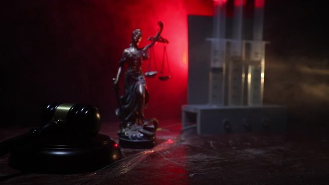 Lethal injection concept. Prisoner handcuffed to death by lethal injection. Creative artwork decoration with scale model on dark with lights.
