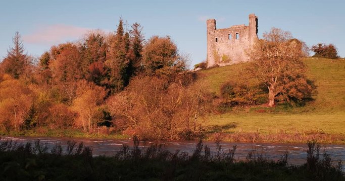 Colorful 4K video of Boyne valey, river and surroundings with Dunmoe castle on thee background, during sunny golden autumn evening, Co. Meath, Ireland
