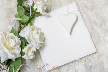 white book with bouquet of roses and white heart, concept of love