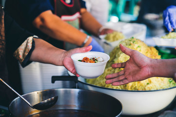 Volunteers provide free food to the underprivileged: sharing food with humans in society