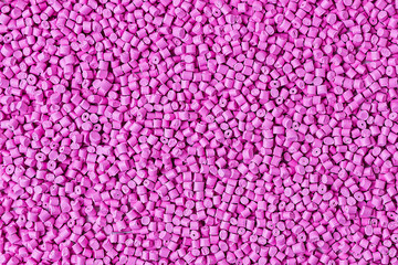 Background of plastic granules. Abstract background color pink