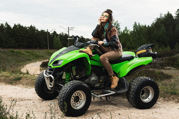 Stylish and beautiful woman and the ATV