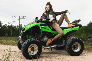 Fototapeta na wymiar Stylish and beautiful woman and the ATV