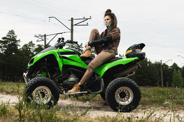 Stylish and beautiful woman and the ATV
