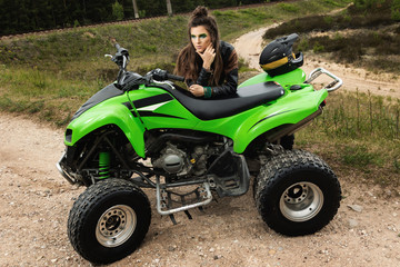 Stylish and beautiful woman and the ATV