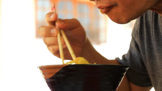 Man eating noodles   , outdoor  Chiangmai Thailand