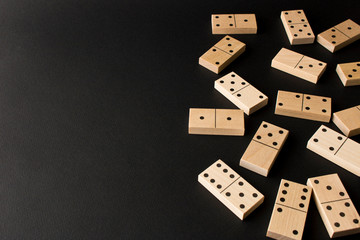 Playing dominoes on a dark background. Leisure games concept. Domino effect. Selective focus.