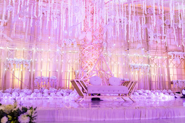 Crystal and gold decor at a wedding lit by purple lights