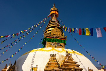 Swayambhunath or Monkey temple is an ancient religious architecture atop a hill in the Kathmandu Valley with a clear blue sky from Swayambhu, west of Kathmandu City, Nepal