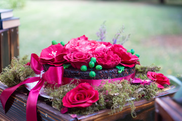 A cake decorated with red flowers