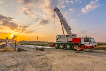 Crane trucks in the construction of a bridge