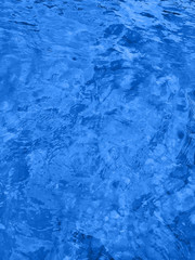 Classic blue color of 2020. Water surface with ripples. Natural background