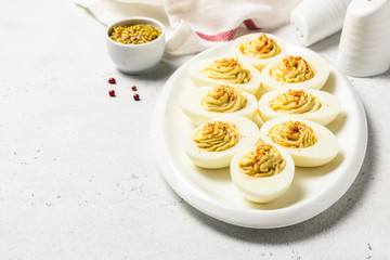 Classic devilled eggs with mustard and smoked paprika. Selective focus, copy space.