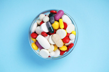 A bowl with colorful medicine pills	