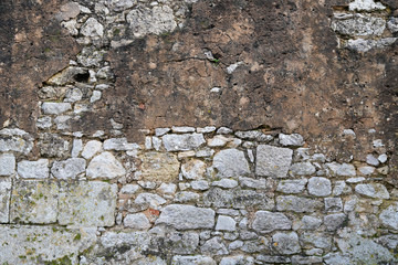 weathered stone brick wall with plaster peeling off real background grunge texture
