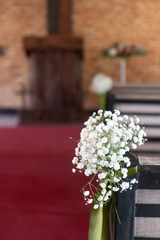 Flowers decorating the aisle at a wedding ceremony