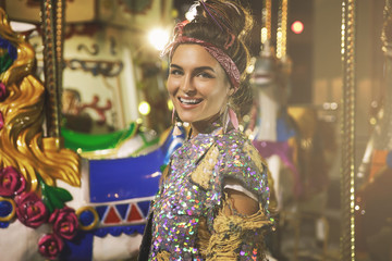 Obraz premium Stylish woman wearing sparkling jacket on the carousel