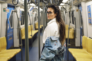 Sexy model is posing in carriage of metro train