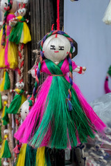 Colourful decorative wall hangings, dolls made of jute, handicrafts for sale (Selective Focus)