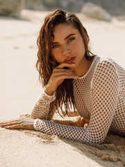 Attractive young woman in bikini relax at tropical beach. Beautiful girl model at ocean coast