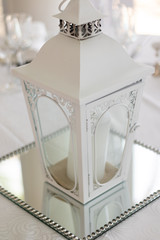A lantern as a centerpiece at a wedding reception