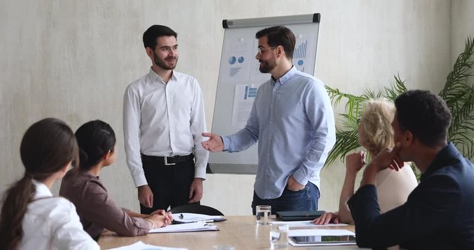 Best male company employee being rewarded at team meeting