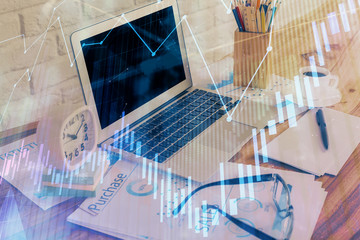 Stock market chart hologram drawn on personal computer background. Double exposure. Concept of investment.