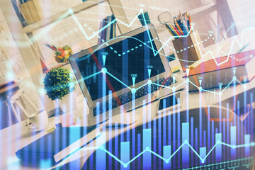 Financial graph colorful drawing and table with computer on background. Double exposure. Concept of international markets.