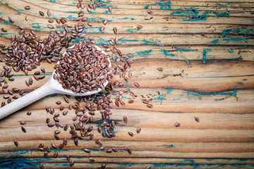 Linseeds and a spoon on a old wooden table