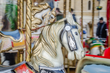 Obraz na płótnie Canvas Novi Sad, Serbia - December 13. 2019: Downtown Novi Sad. The decorations on the children's carousel with wooden horses
