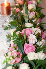 The main table decorated with roses at a wedding reception