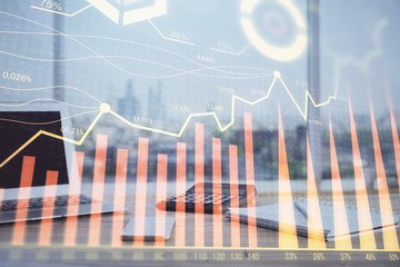 Forex Chart hologram on table with computer background. Multi exposure. Concept of financial markets.