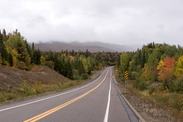 Fototapeta na wymiar Empty street in the Mauricie National Park in Indian Summer. Canada