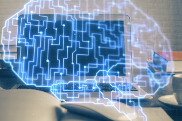 Multi exposure of work table with computer and brain hologram. Brainstorm concept.