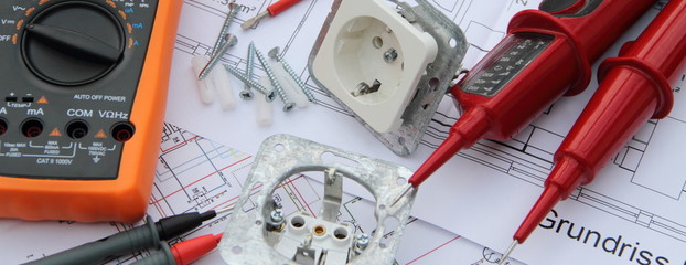 Sockets with a screwdriver and a measuring device on a circuit diagram