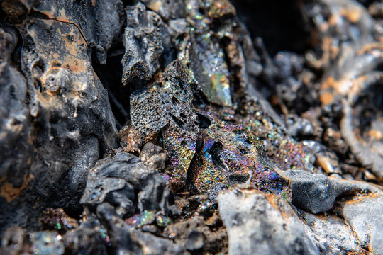 rainbow of colours of sparkling minerals in a lava flow, outside of picture blurred to give effect