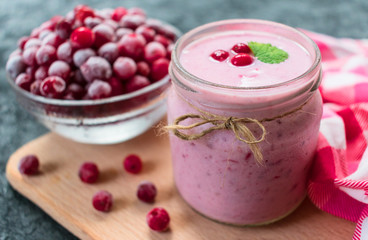 Frozen cranberry yogurt on a black background. The concept of healthy desserts. Close-up.