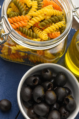 Italian or Greek olive oil with spaghetti or pasta and olives. Vertical frame