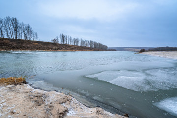 panorama of winter landscape, frozen river, blue sky . snow