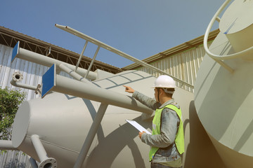 Mechanic engineer holding a note in the champagne bucket factory
