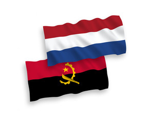 National vector fabric wave flags of Angola and Netherlands isolated on white background. 1 to 2 proportion.