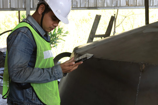 Mechanic Engineer Holding A Ipad In The Champagne Bucket Factory