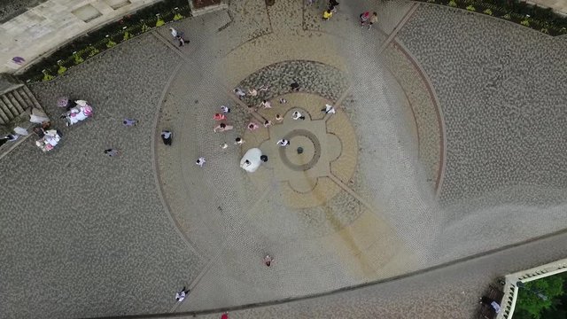 bride and groom dancing flashmob with friends, people dancing flashmob around the bride and groom top view from the quadcopter