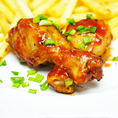 Chicken legs with french fries potatoes